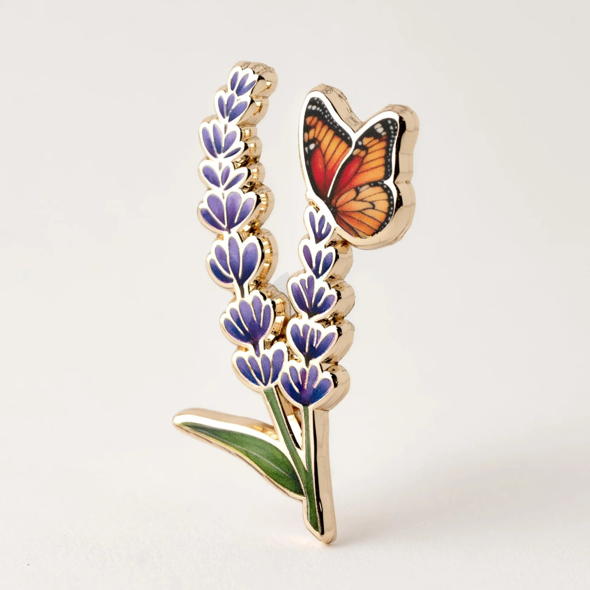 lapel pin with butterfly on lavender flowers on a white background