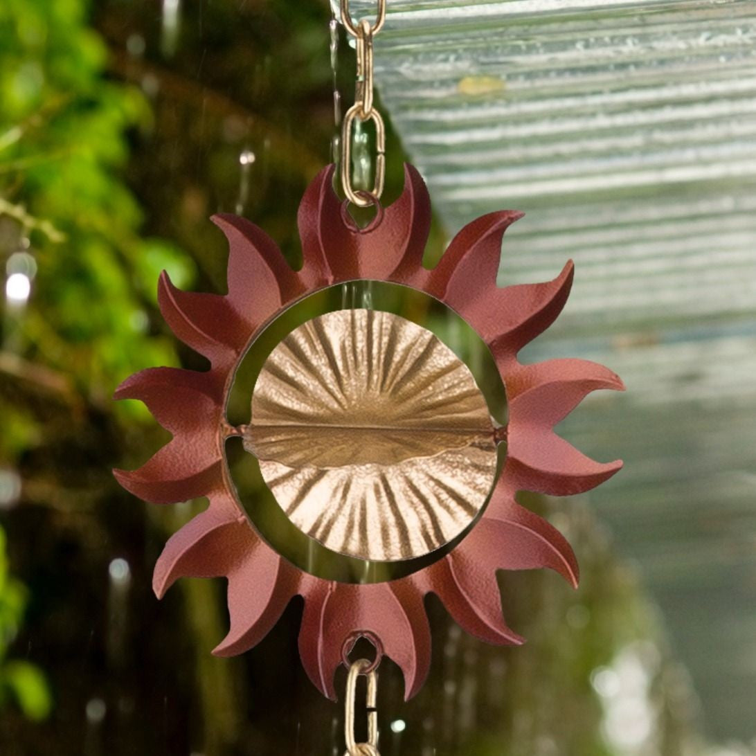 a close up of a single sun from the sun rain chain with a rainy garden in the background