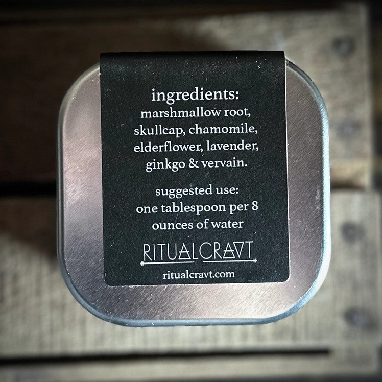 the back of the mercury retrograde tea tin listing ingredients and preparation method on an elegant black label