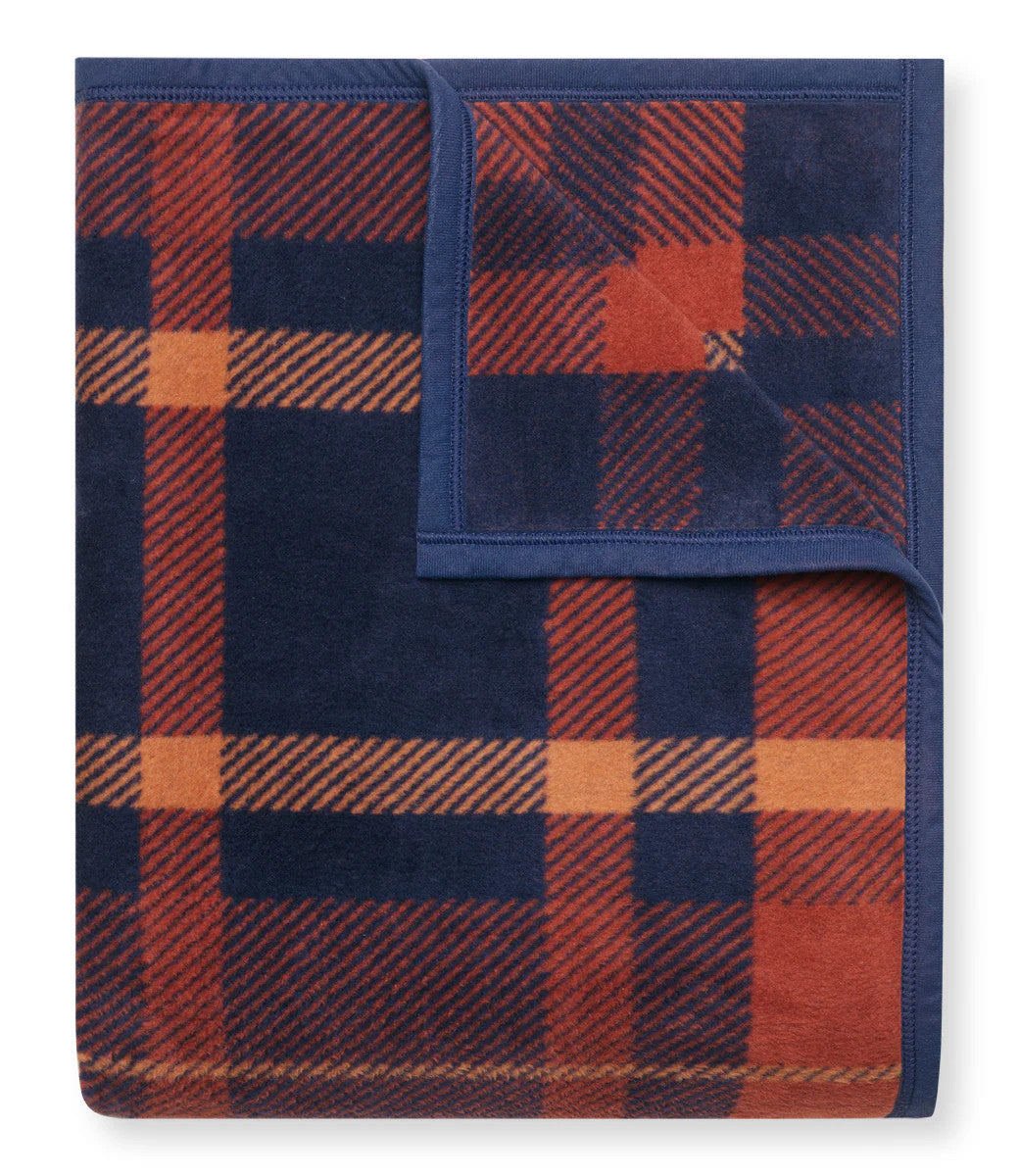 A folded Sebago Tartan blanket with the top right corner folded over to show the reverse of the design
