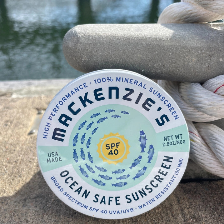 a tin of spf 40 sunscreen on a dock
