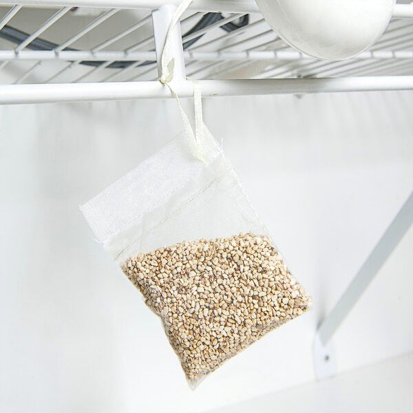 the scent away pouch hanging from a white wire kitchen shelf