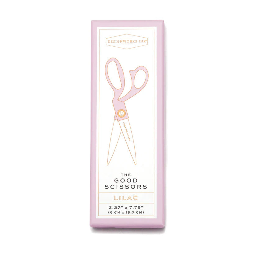 a white rectangular box against a white background - the box has a light purple border and a line drawing of the scissors with purple handles and "looking sharp" printed on the blade of the scissors. The Designworks Ink logo is at the top of the box, the text at the bottom of the box reads "The Good Scissors", "Lilac", "2.37 inches by 7.75 inches"