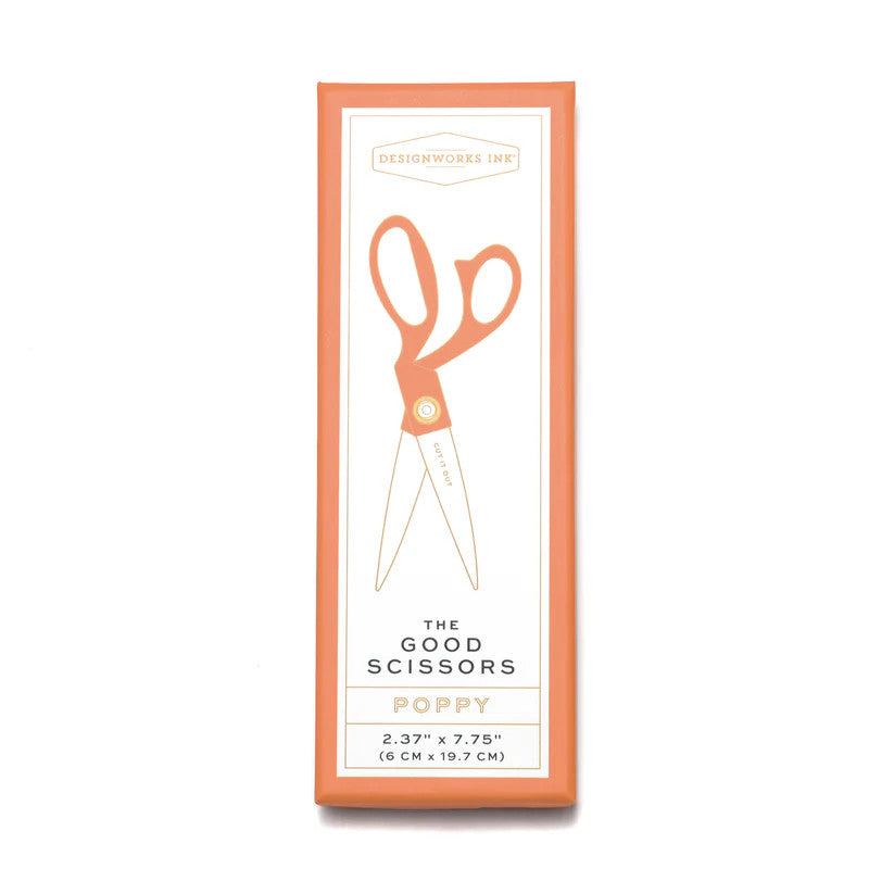 a white rectangular box against a white background - the box has a light orange border and a line drawing of the scissors with orange handles and "Cut it Out" printed on the blade of the scissors. The Designworks Ink logo is at the top of the box, the text at the bottom of the box reads "The Good Scissors", "Poppy", "2.37 inches by 7.75 inches"