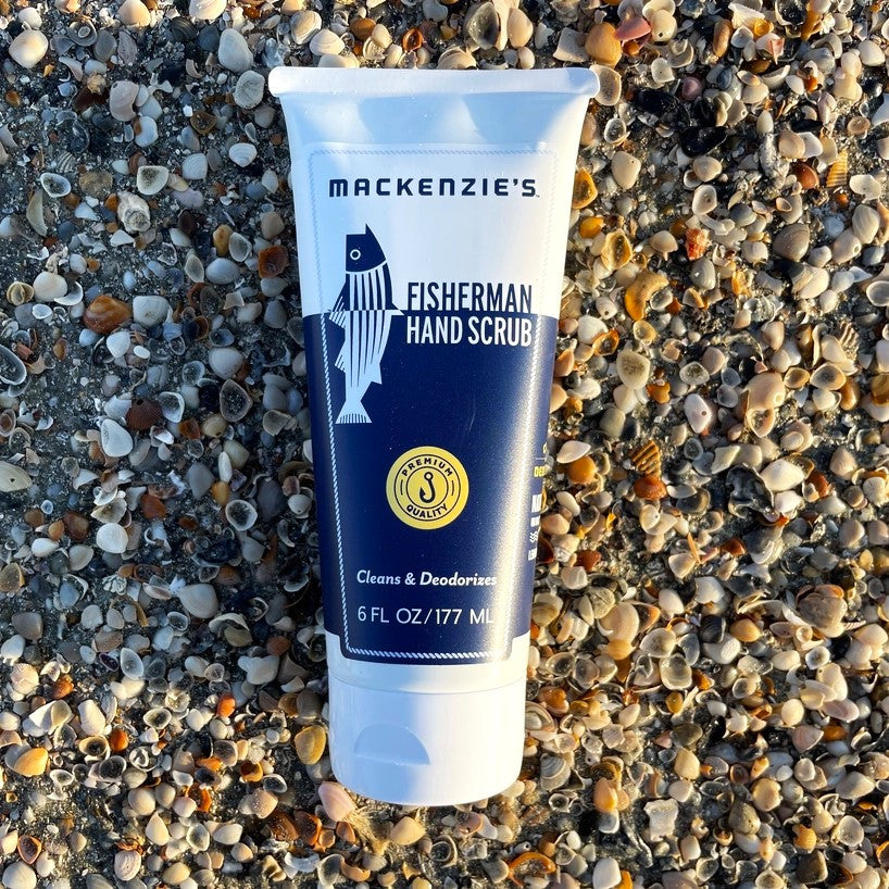 a bottle of the Fisherman Hand Scrub on a pebbled beach