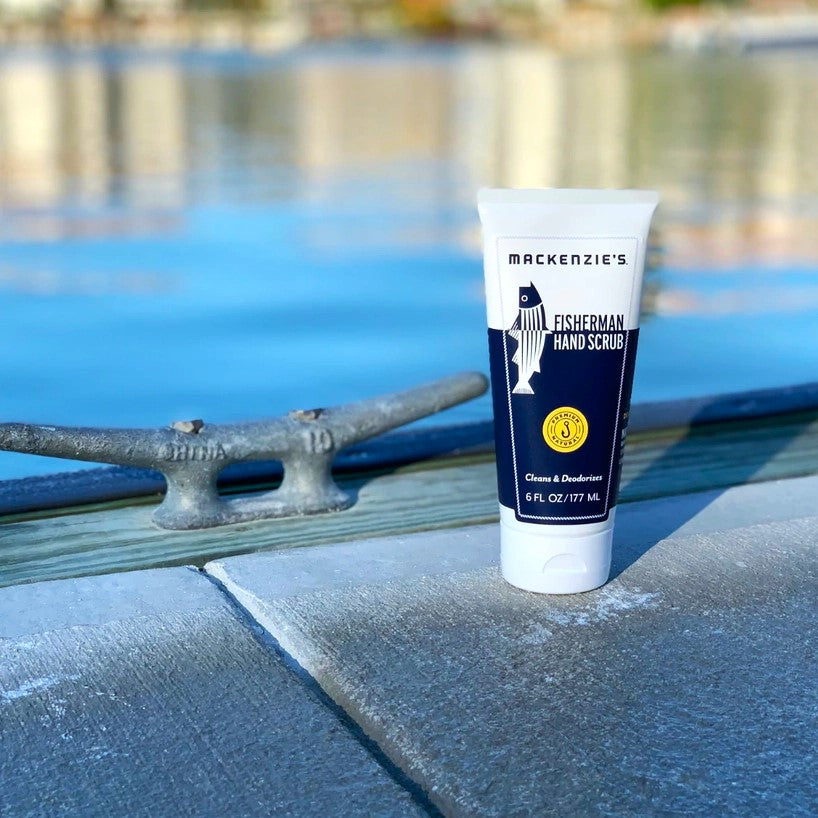 a bottle of the Fisherman Hand Scrub on a dock in a harbor