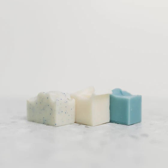 a trio of mini soaps in subtle ocean inspired colors in a line
