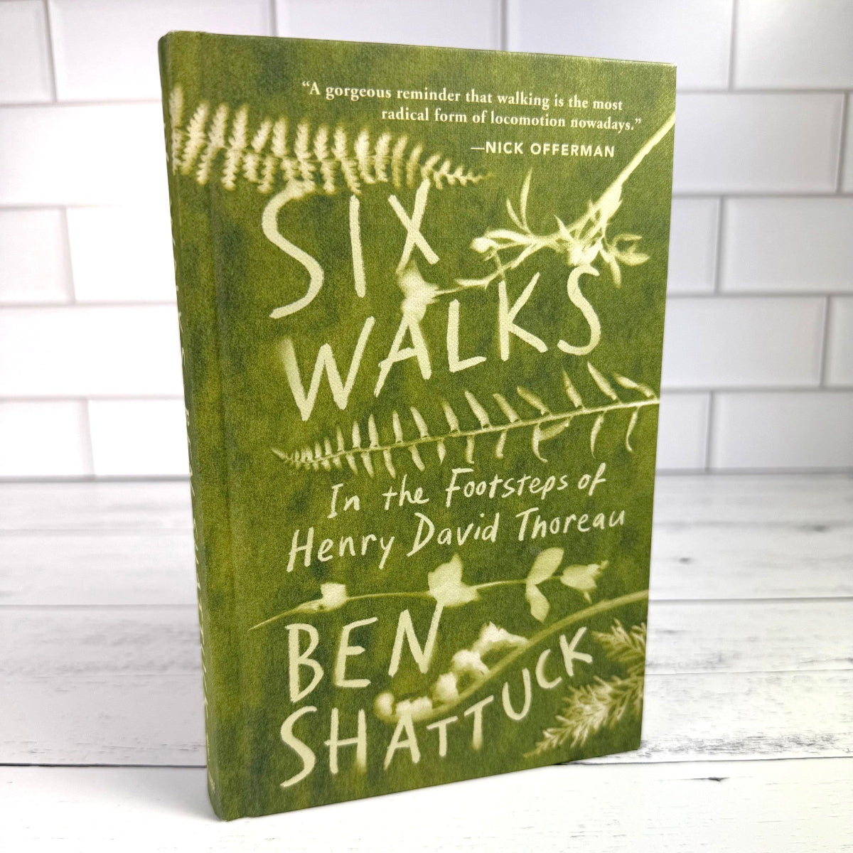 Six Walks book on a white book surface standing upright against a white tile background