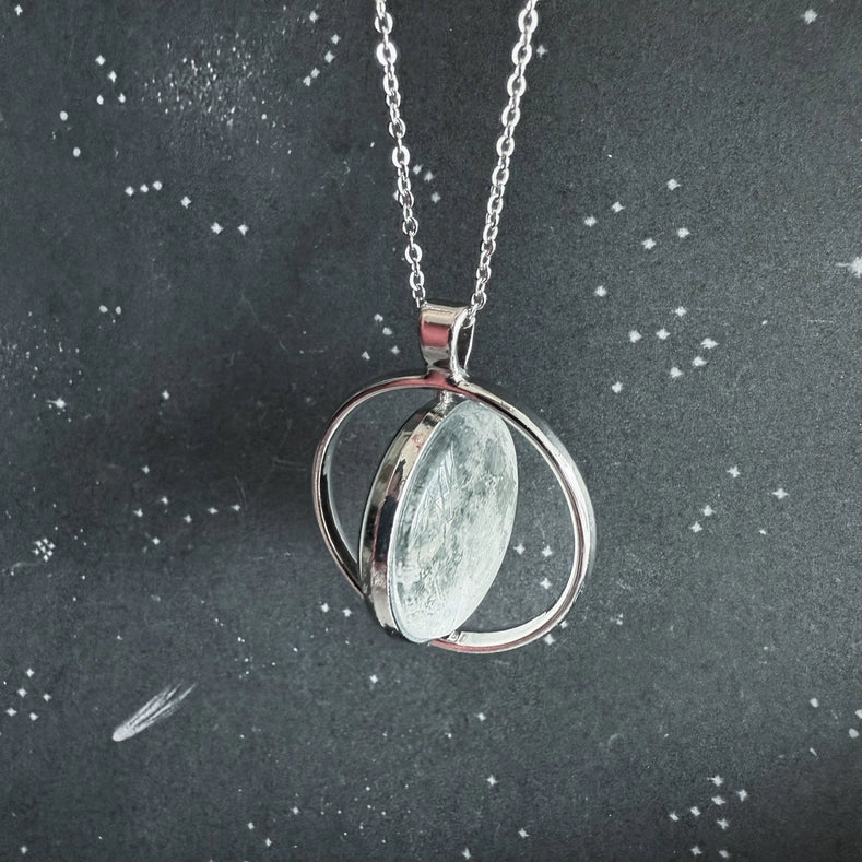 Silver necklace with a pendant on a dark background