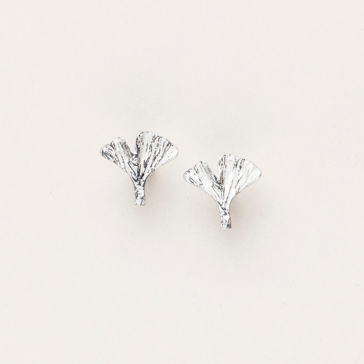 pewter ginkgo leaf stud earrings with intricate hand-crafted detail and high shine silver color