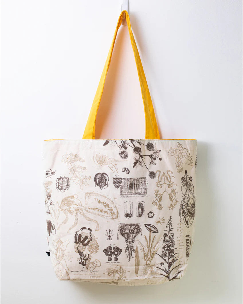 side two of the honey bee tote; a white tote bag with yellow straps covered in vintage illustrations and academic diagrams of the honey bee