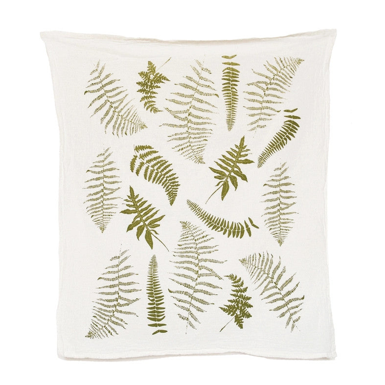 an off white tea towel with illustrations of green fern fronds
