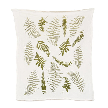 an off white tea towel with illustrations of green fern fronds