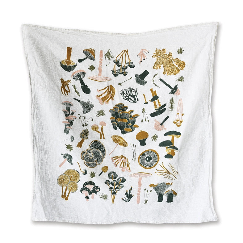 a white tea towel with playful illustrations of a variety of mushrooms