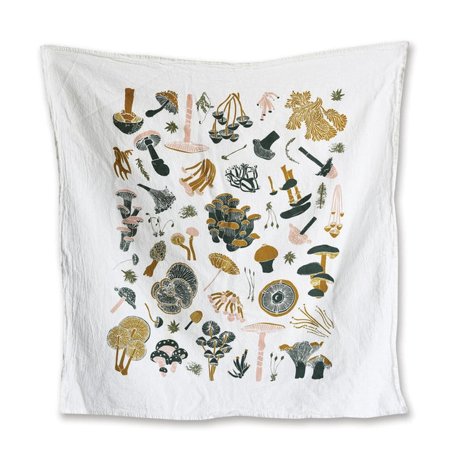 a white tea towel with playful illustrations of a variety of mushrooms
