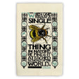 a folded tea towel featuring an illustration of a bee with the John Muir quote, "When one tugs at a single thing in nature, he finds it attached to the rest of the world"