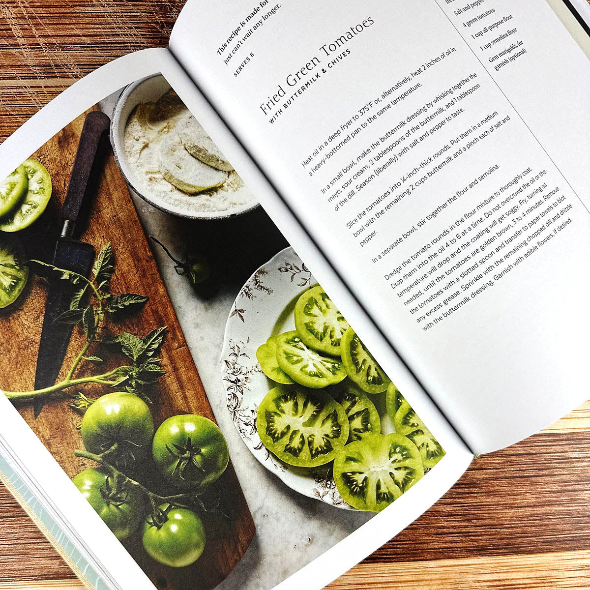 Open cookbook showing images of green tomatoes and a recipe.