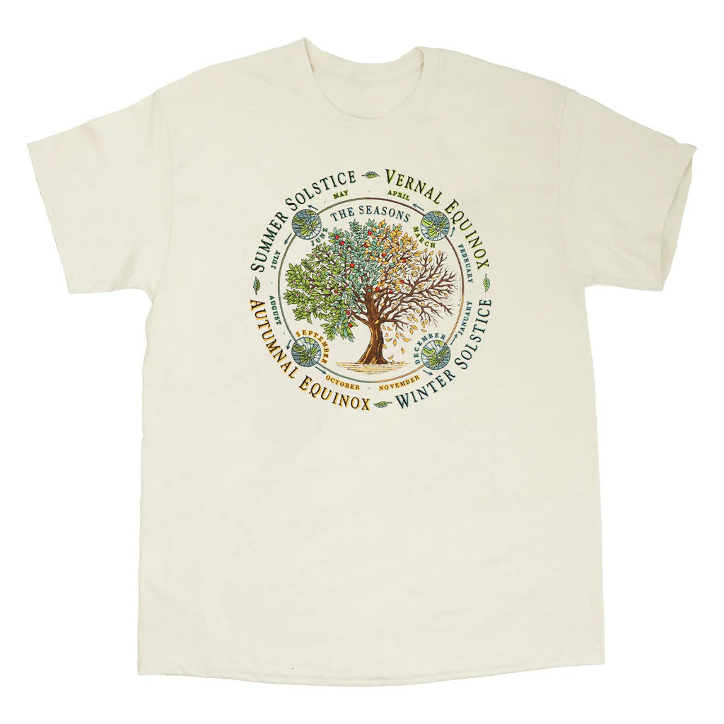 an off white tee shirt with illustration of a tree throughout each of the four seasons. text surrounds the circular design noting the Vernal Equinox, Summer Solstice, Autumnal Equinox, and Winter Solstice