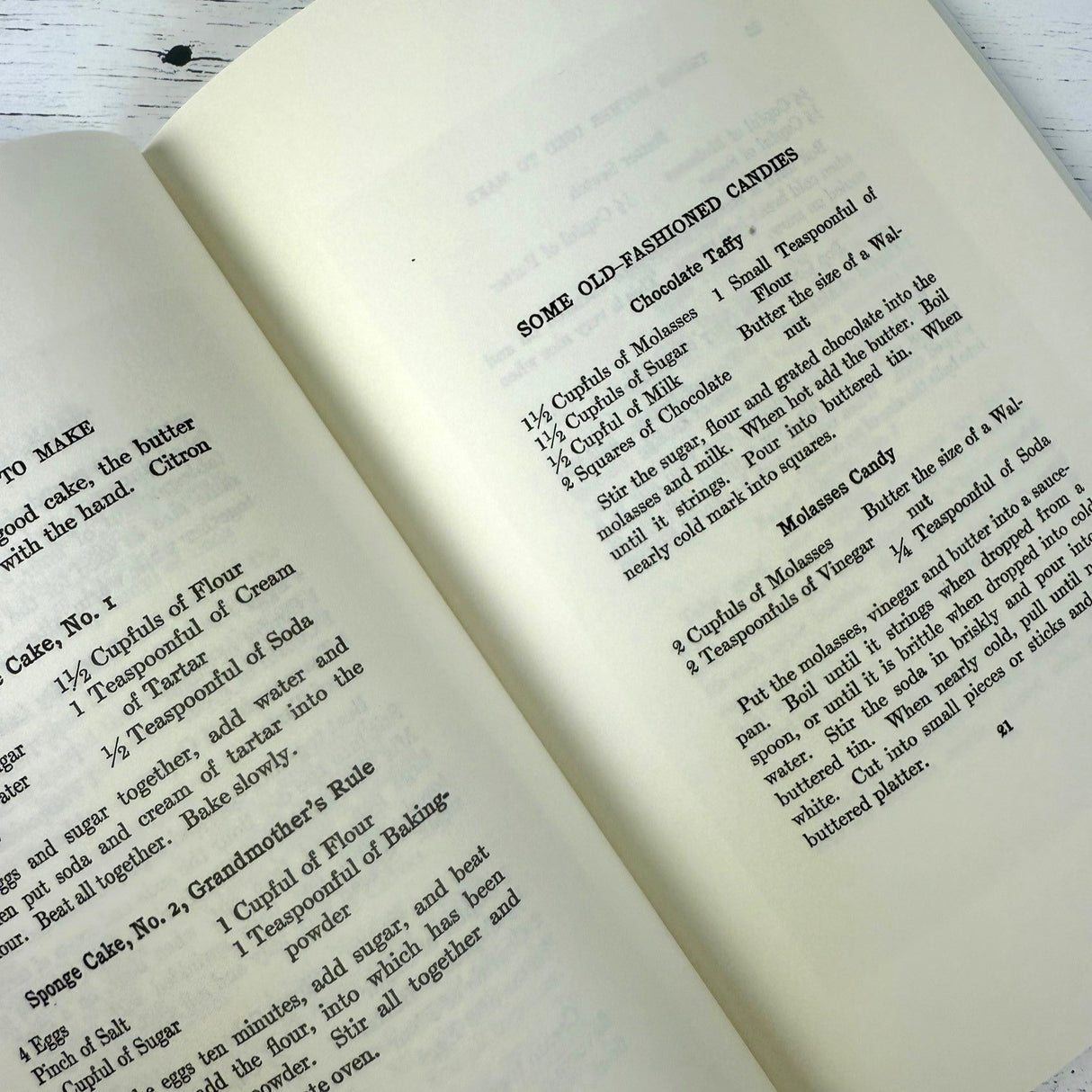 Open book with vintage-style recipe text on a wooden surface