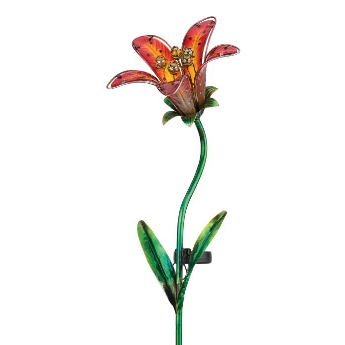 a close up of the red tiger lily solar stake against a white background