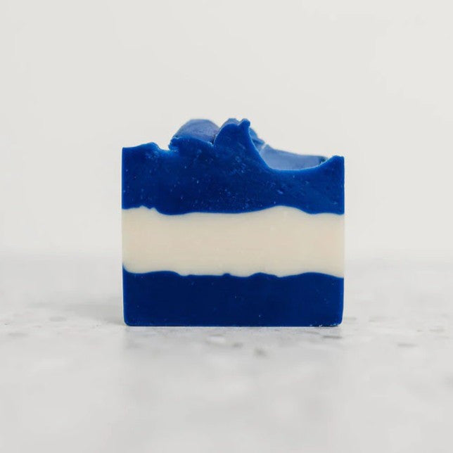 the blue and white striped ultramarine bar soap against a white background