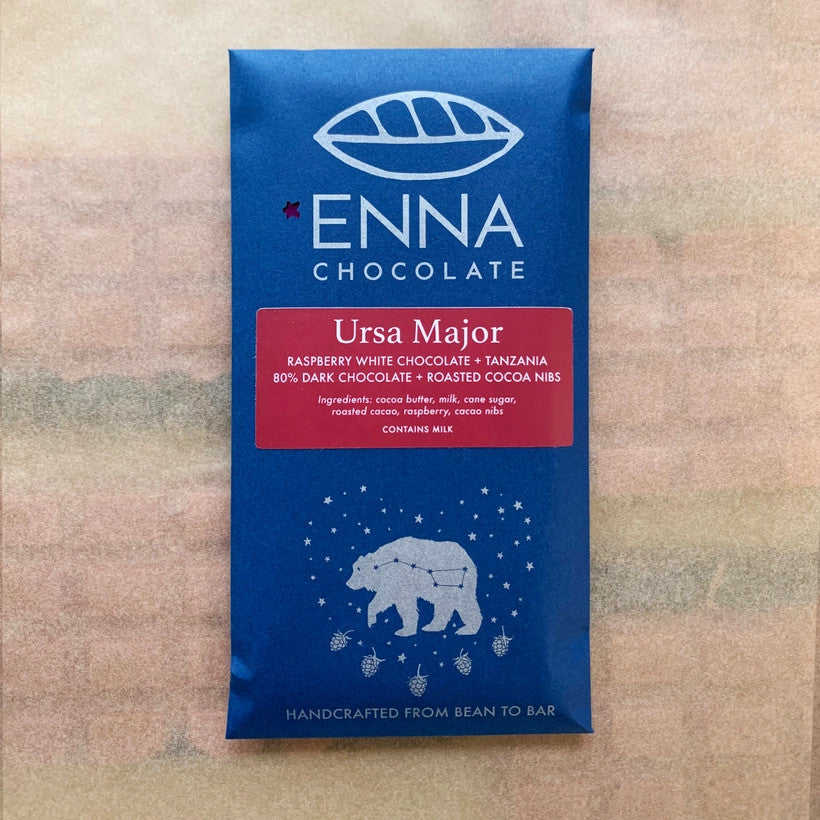 royal blue chocolate bar package with red label for the Ursa Major Bar featuring the Ursa Major constellation, surrounded by a bear silhouette, shining stars, and five raspberries