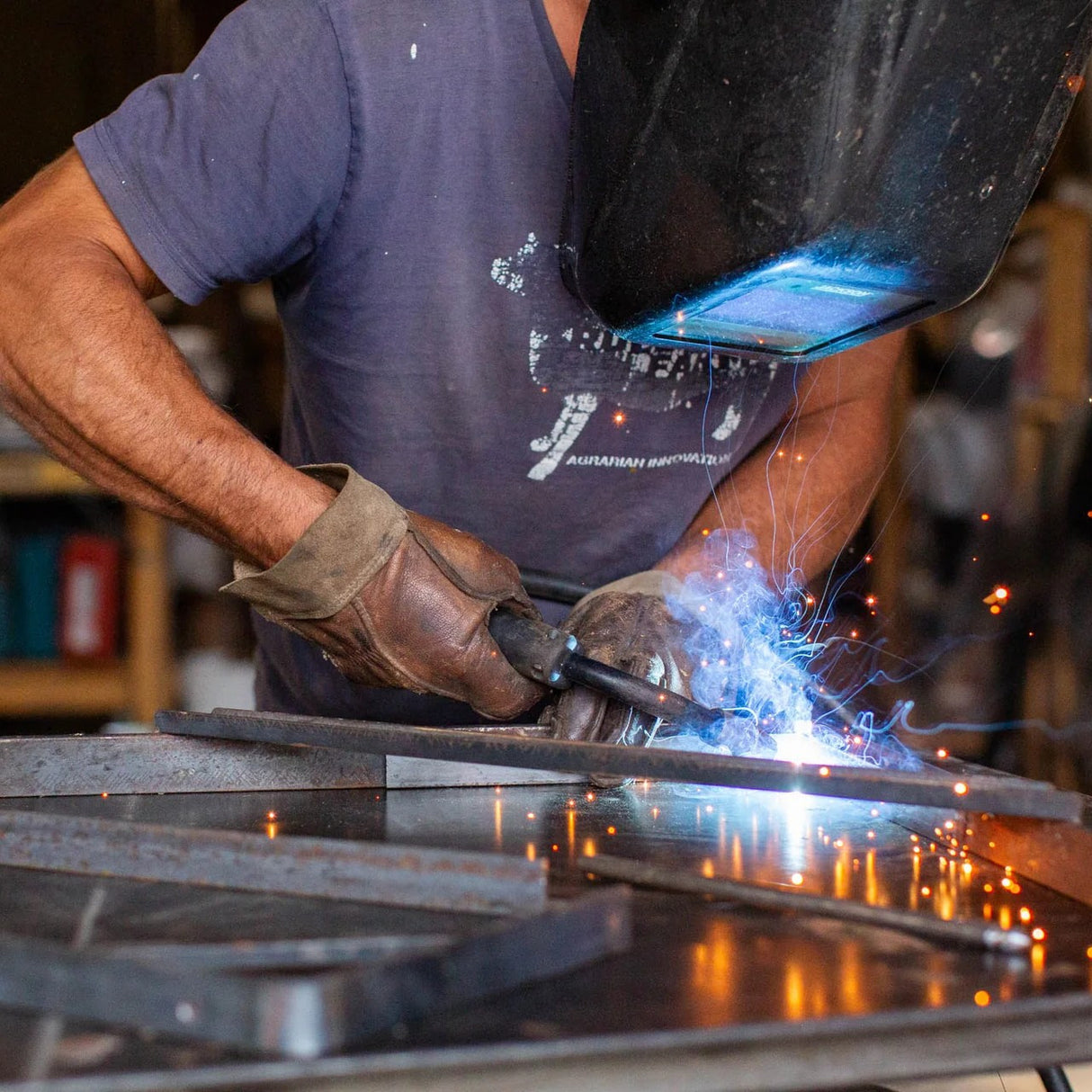a welder wearing the vermoter gloves in a workshop