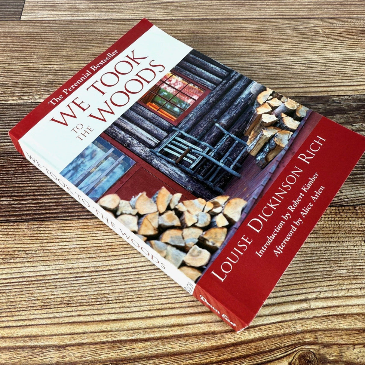 We Took to the Woods book on rustic wood surface shown laying diagonally