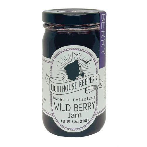 a jar of wild berry jam with a white label with a logo of a silhoutted man in a captain's hat smoking a pipe with seagulls flying behind him