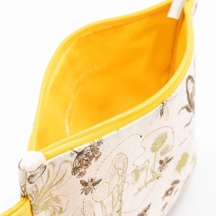 a close up of the honey bee zipper pouch showing the pouch unzipped revealing the solid yellow lining