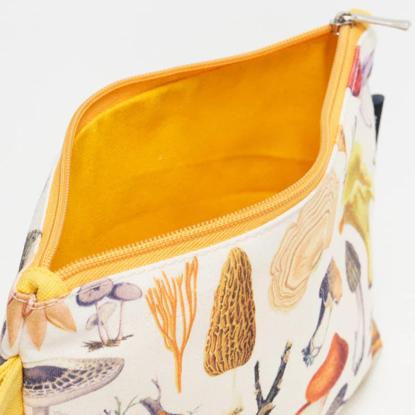 a close up of the woodland mushrooms zipper pouch showing the pouch unzipped revealing the solid goldenrod yellow lining