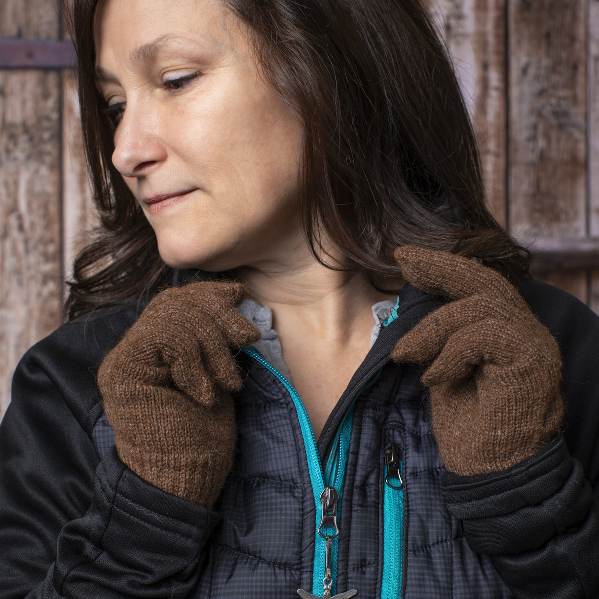 a model wearing the brown gloves adjusts her collar