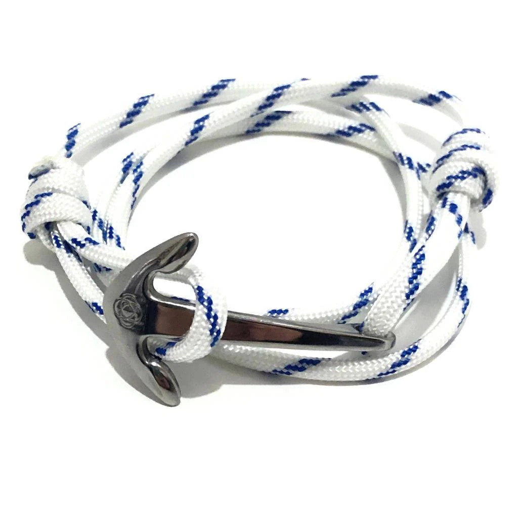 a white with blue stripes wrap bracelet made of cord that is held in place with a silver anchor charm