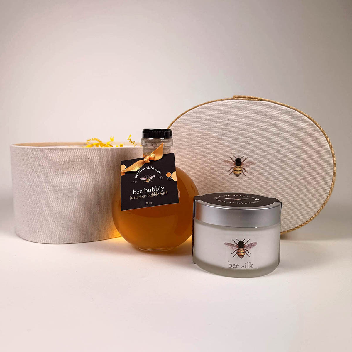 the Bee Bubbly and Bee Silk posed in front of the Beekeeper hat box