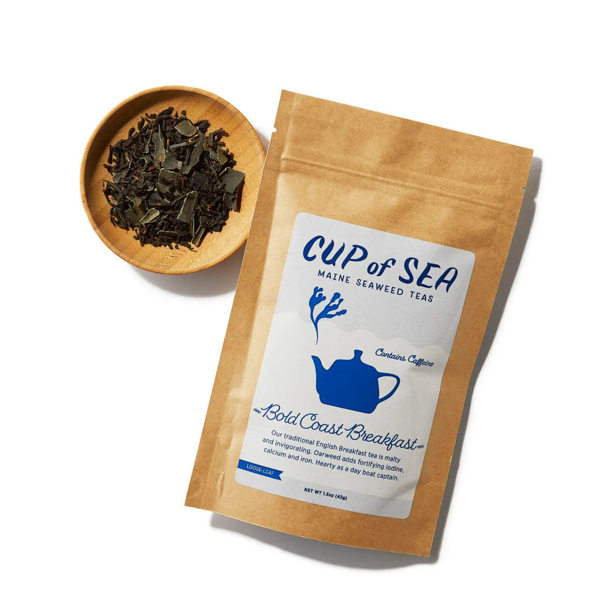 a kraft tea package with a white and blue label that reads "Cup of Sea - Maine Seaweed Teas - Bold Coast Breakfast" with a graphic of a solid blue tea kettle with seaweed shaped steam rising out of the spout next to a small round bowl filled with loose leaf tea