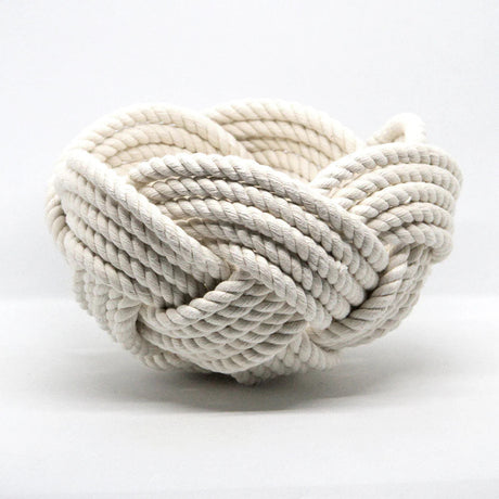 a hand woven cotton rope bowl in white against a white background