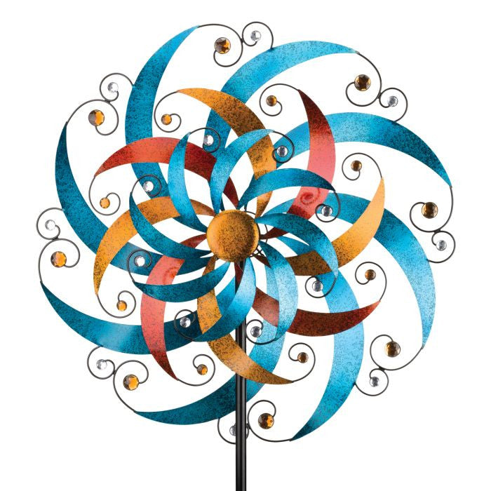 Close-up view of the crescent-shaped blades and sparkling faceted acrylic gems on the Triple Wind Spinner, with metallic blue, gold, and copper paint shimmering in the sun