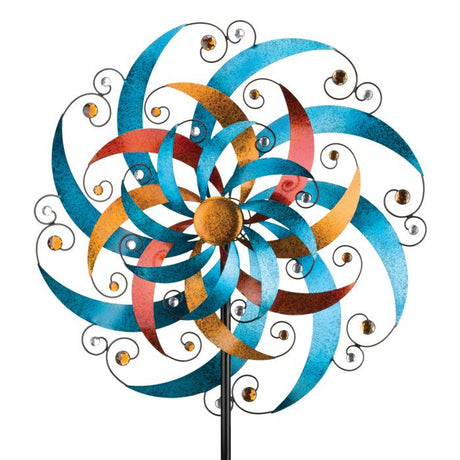 Close-up view of the crescent-shaped blades and sparkling faceted acrylic gems on the Triple Wind Spinner, with metallic blue, gold, and copper paint shimmering in the sun