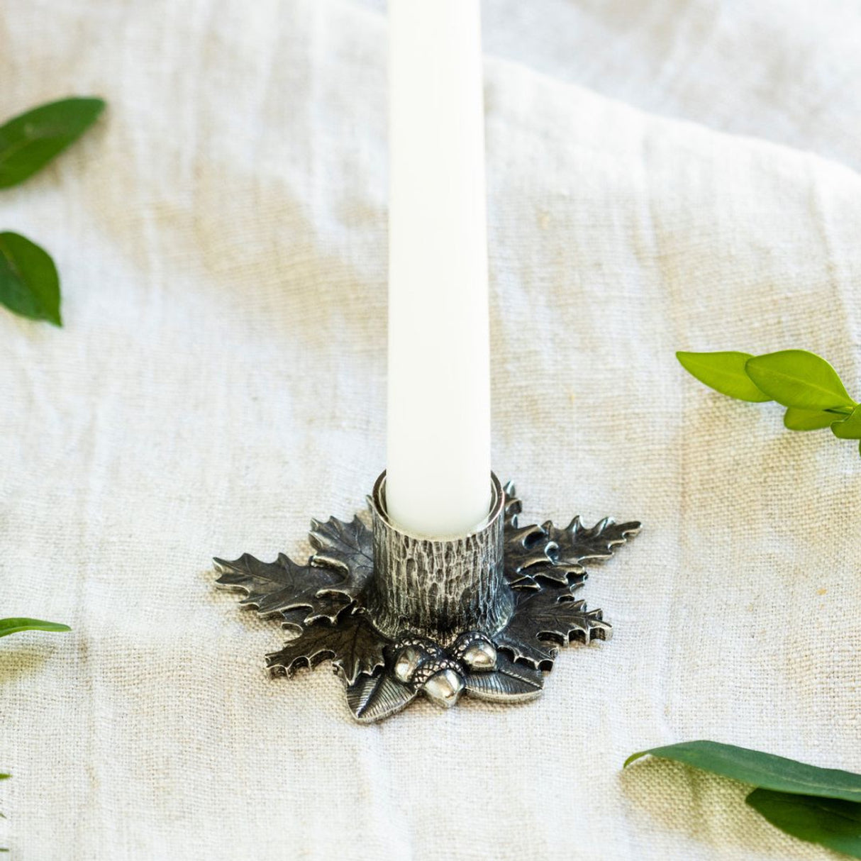 a linen table setting with the autumn leaves candle holder with a white candle