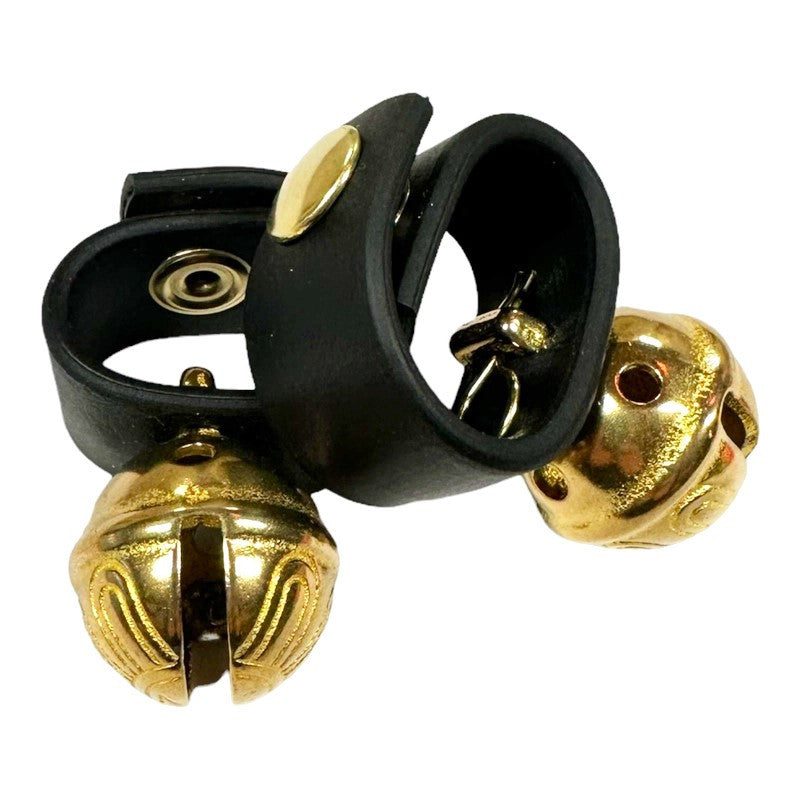a pair of Dog Collar Bells - brass bell on a black leather loop with a snap closure