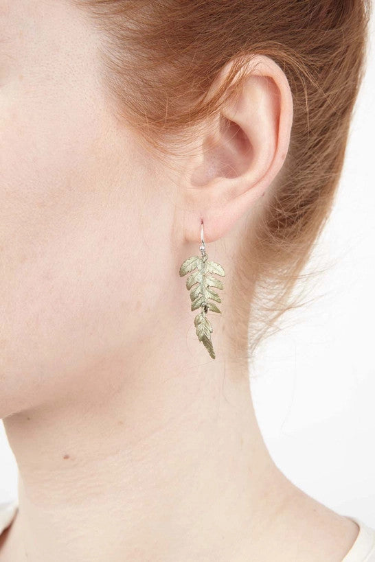 a close up of a model's ear wearing the Fern Earrings