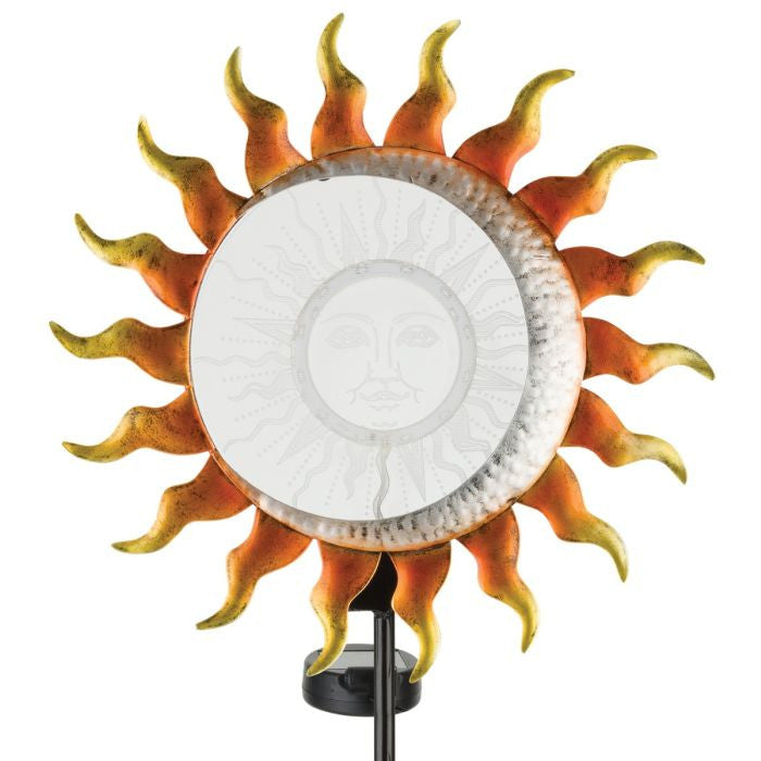 Close-up of the solar stake’s sun centerpiece, with etched sun design and amber LED lights