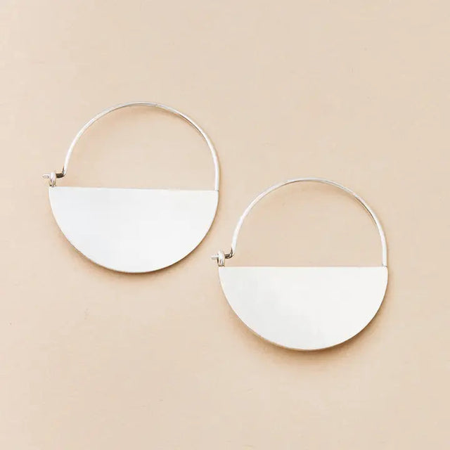 a pair of silver hoop earrings that form a half circle like a half full moon