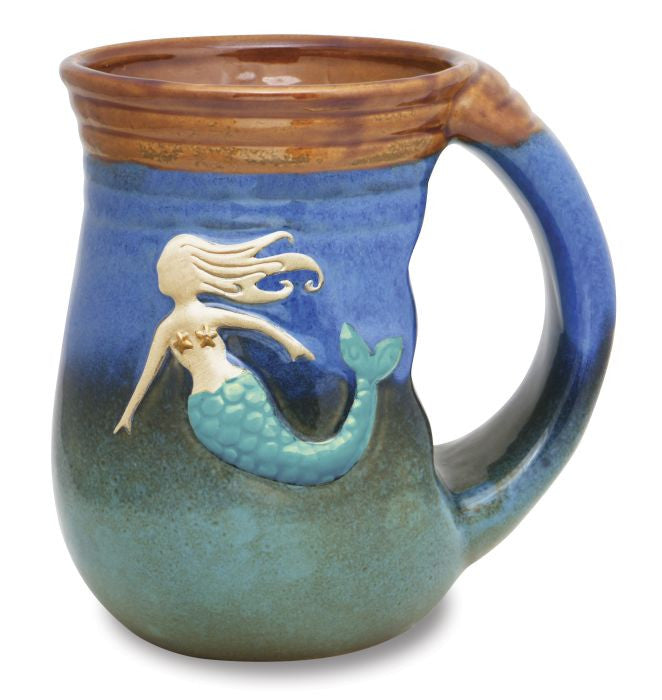 ceramic mug with ombre glaze that ranges from sea green to cobalt blue with a raised mermaid design