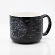 the other side of a black coffee mug with printed astronomy charts of the night sky and constellations