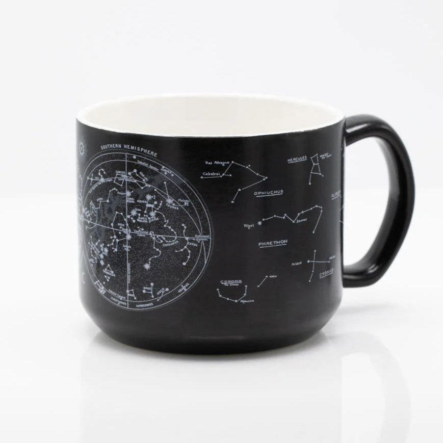 the other side of a black coffee mug with printed astronomy charts of the night sky and constellations