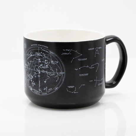 the other side of a black coffee mug with printed astronomy charts of the night sky and constellations