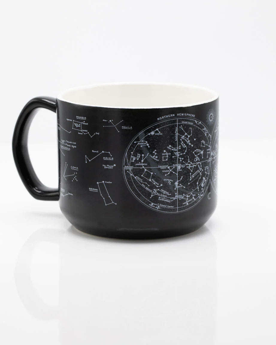 a black coffee mug with printed astronomy charts of the night sky and constellations