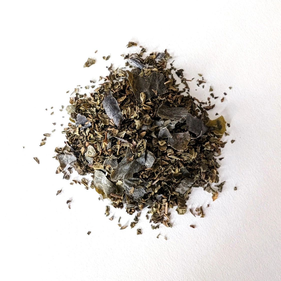 a small mound of loose leaf Ocean Mint tea showing the seaweed and mint blend