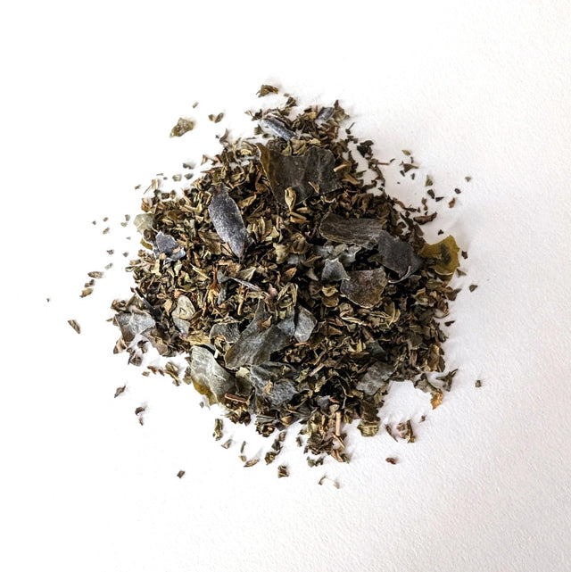 a small mound of loose leaf Ocean Mint tea showing the seaweed and mint blend
